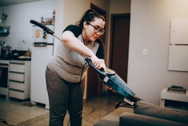 Person vacuming couch